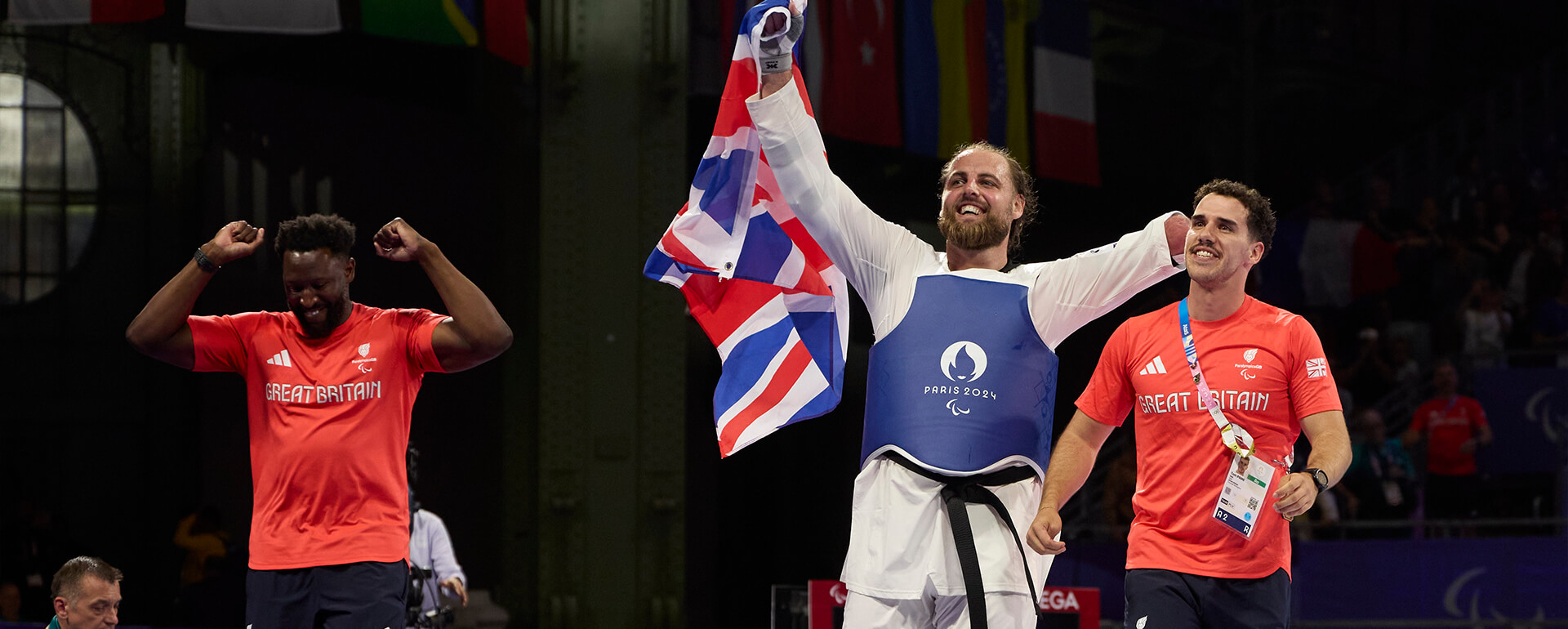 Matt Bush and his coaches celebrate winning Gold in Mens Para Taekwondo 80kg+ at the Paris 2024 Paralympic Games