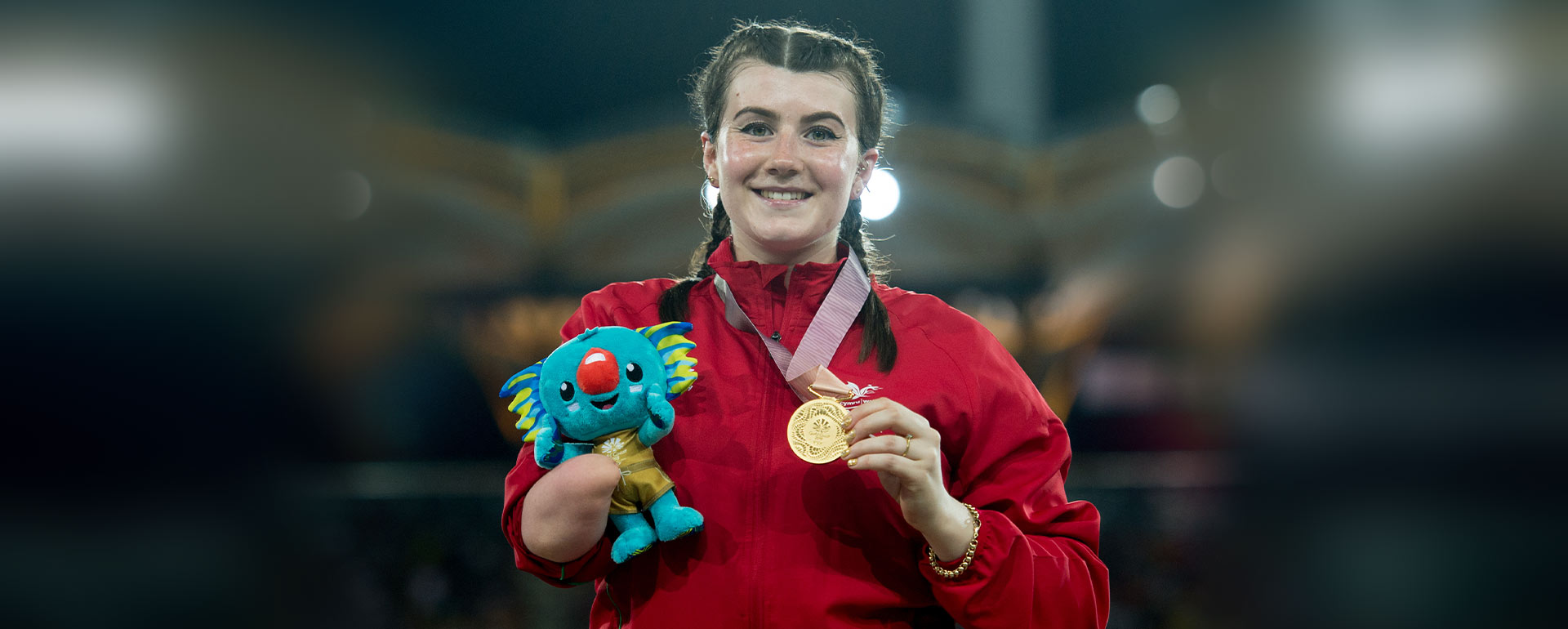 Hollie Arnold smiles holding up her gold medal from the Gold Coast 2018 Commonwealth Games